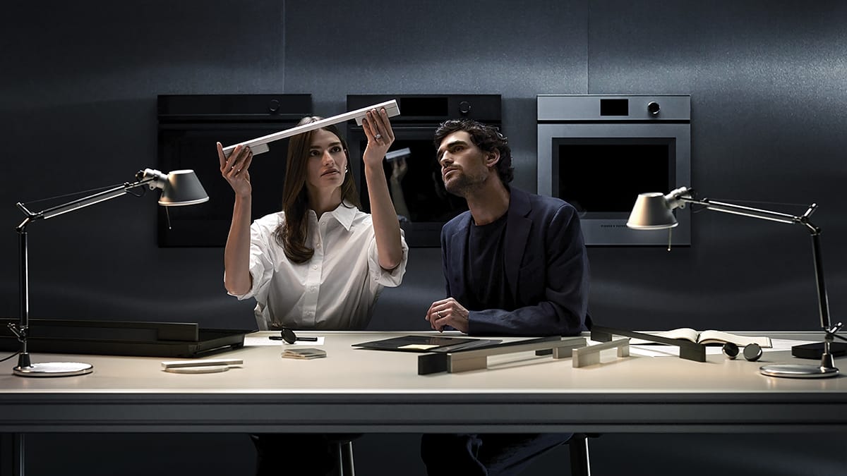 Designers discussing oven door.