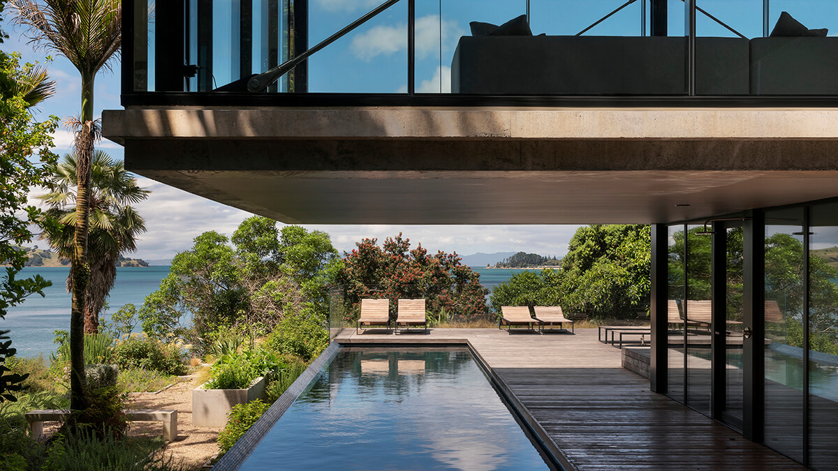 Exterior view of Mahuika beach house looking across the pool to the sea view.
