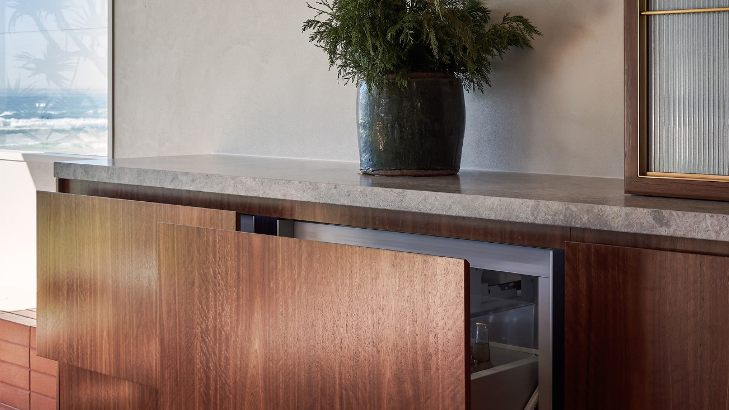 Integrated fisher and paykel fridge freezer matches the dark charcoal timber cabinetry