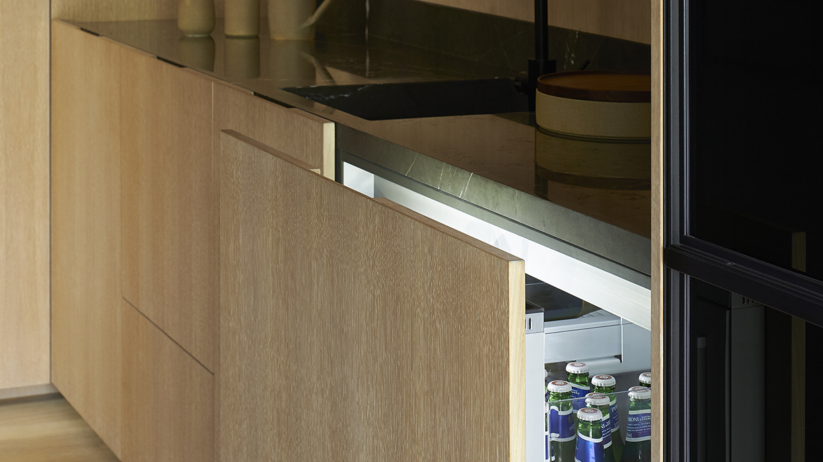 a Fisher & Paykel CoolDrawer&trade; slightly open revealing beer bottles